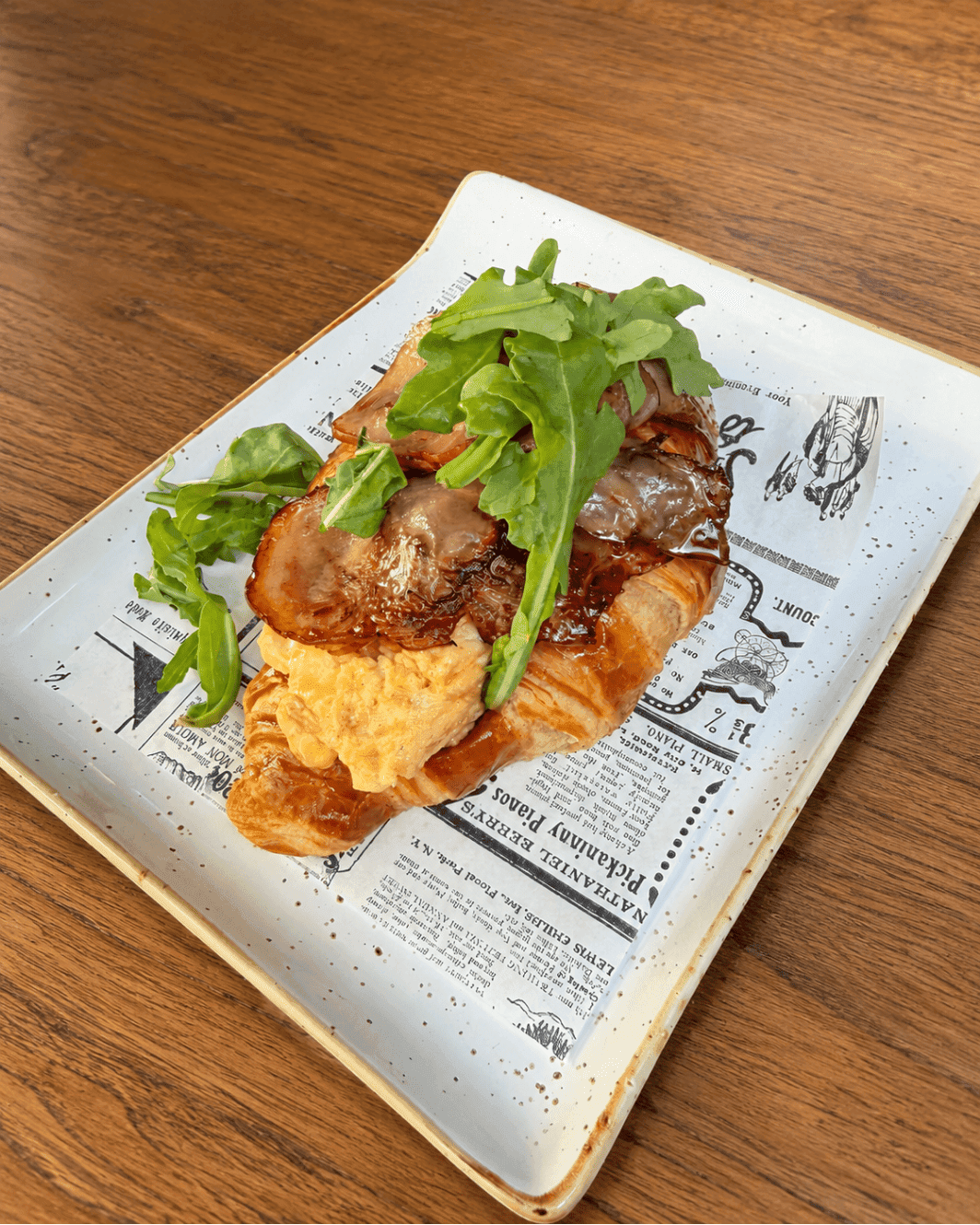 The Morning Club: butter croissant with scrambled egg, crispy bacon and rocket